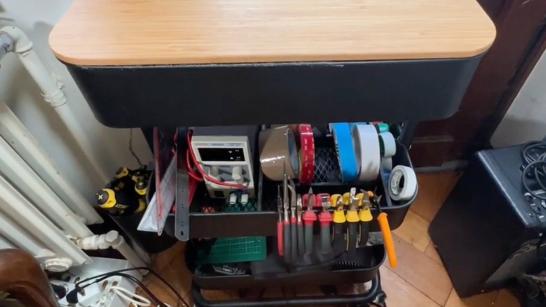 Black RASKOG cart being used as utility cart with tape, pliers, and tools