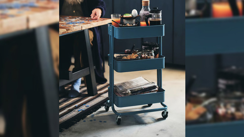 Blue RASKOG cart with glasses full of juice and coffee on top