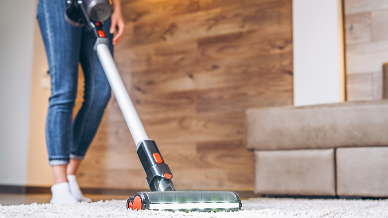 person vacuuming rug