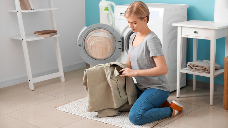 person checking jacket pocket