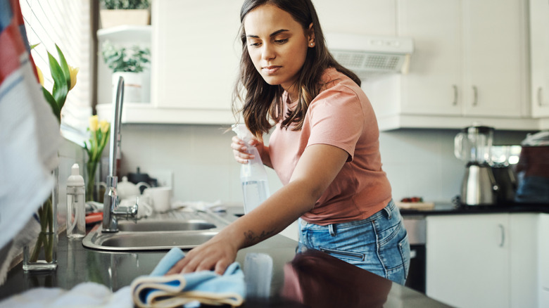person cleaning counter