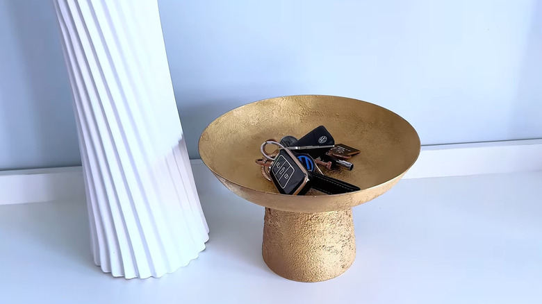 Keys in classy gold textured catch dish made from bowl and vase