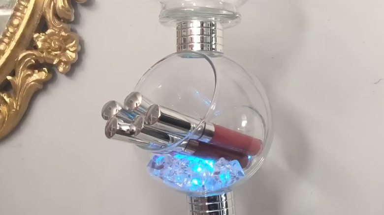 DIY bubble-style vases stacked with glowing crystals and assorted lipsticks inside