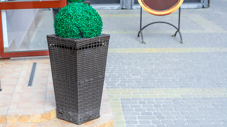 Faux planter trash can to disguise outdoor trash