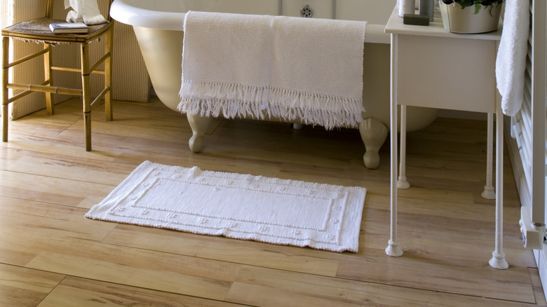 Classy white bathroom with simple room divider in background