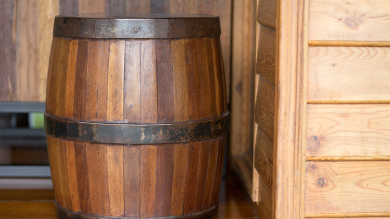 Large vintage whiskey barrel turned into a trash can