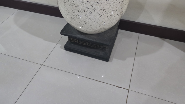 Stone planter pot on floor of home