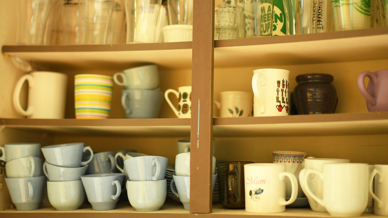 Mugs in kitchen cupboard