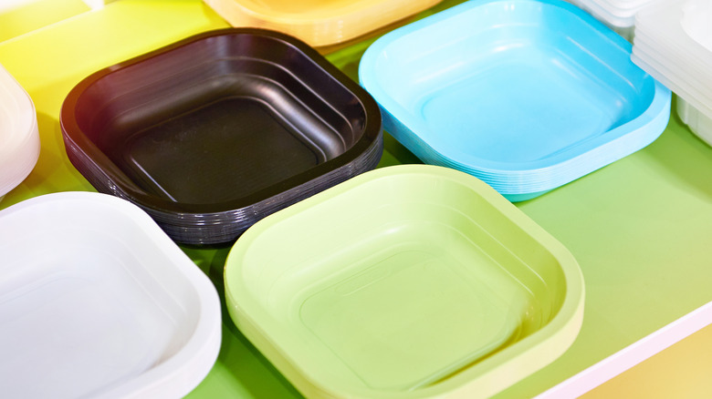 Colorful assortment of disposable plastic plates in drawer