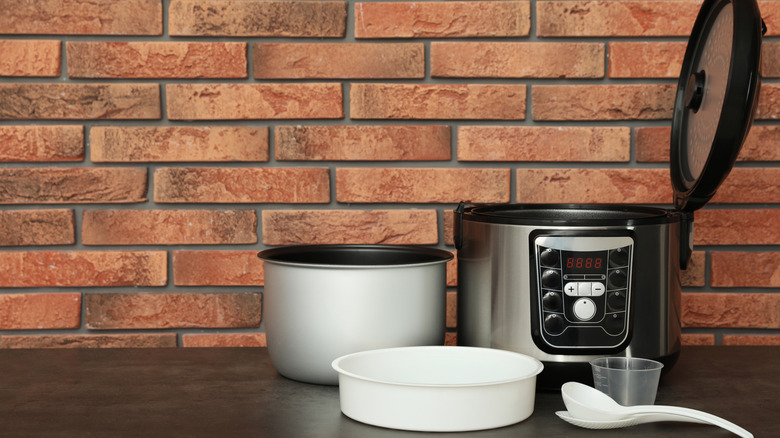 Clean slow cooker prepped and taken apart in rustic kitchen