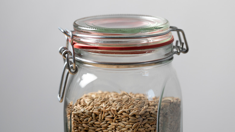 A rubber-sealed jar filled with seeds