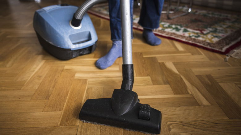 Woman vacuuming the floor