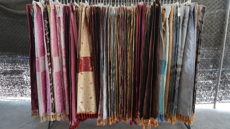rack of used curtains at thrift store