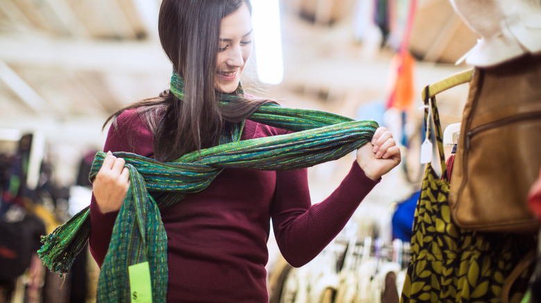 Person trying on scarf at the thrift store