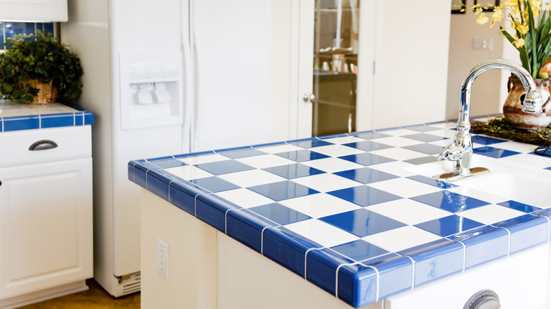Bright white and blue tile checkered kitchen island