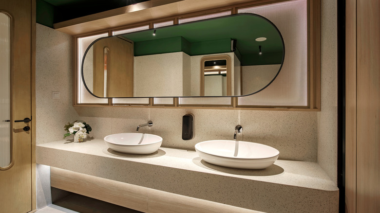 Moody bathroom with terrazzo counter and double sinks