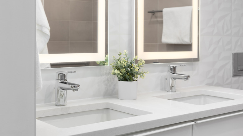 White bathroom with double sinks and mirrors