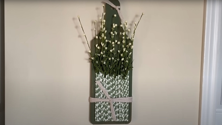 Plastic drinking straw plant holder on dollar store cutting board