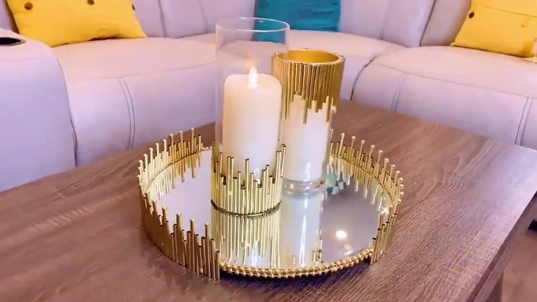 A tray and candleholders embellished with gold painted straws
