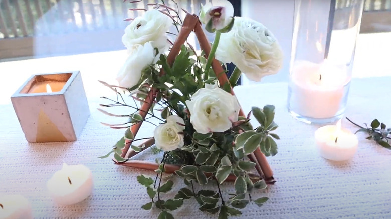 Geometric triangle decor made of plastic straws and dollar store flowers