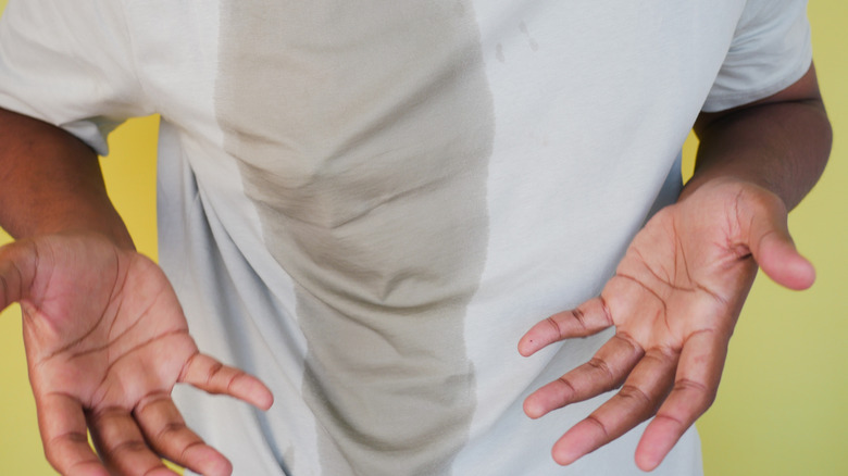 man with water spilled on shirt