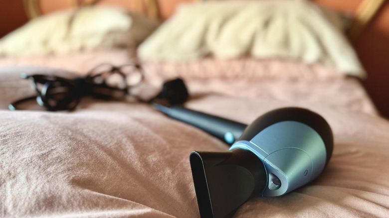 hair dryer laying on bed