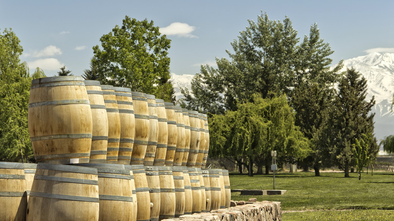 Wine barrels stacked on top of one another in a field