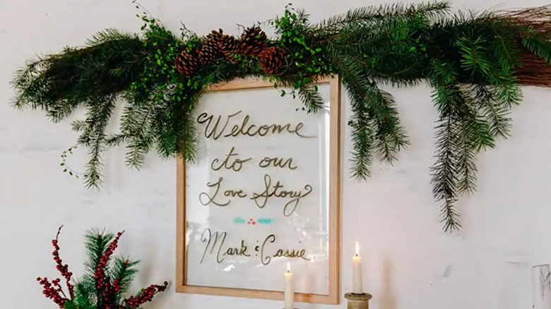 Swag made from two large cinnamon brooms, pine boughs, and pine cones