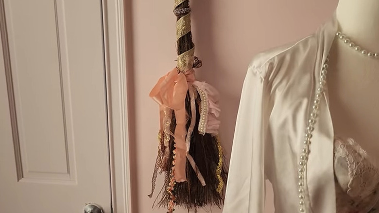 Glam, feminine cinnamon broom decorated with ribbons