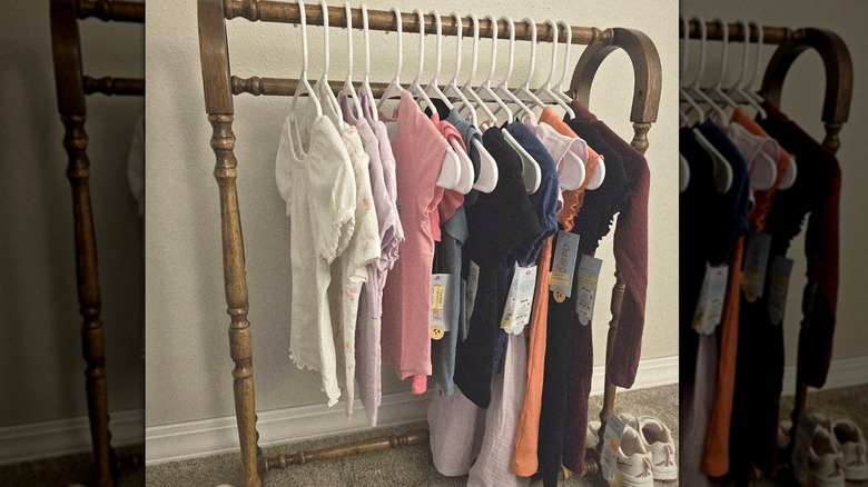 Collection of children's Cat and Jack clothing hung on a wooden quilt rack