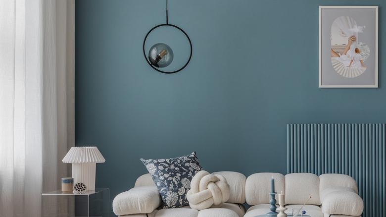 A fully furnished blue and cream living room.