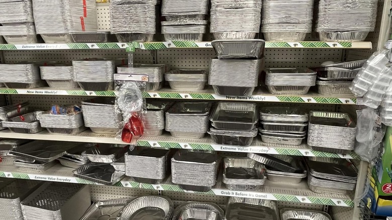 A full range of foil pans in assorted shapes and sizes on the shelves in Dollar Tree.