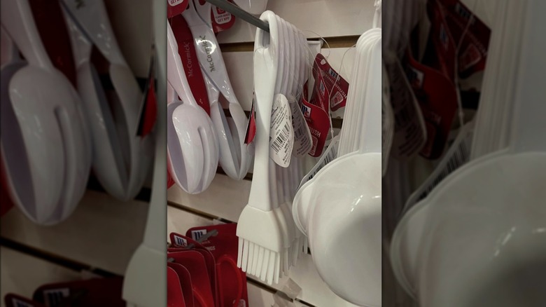 A White McCormick silicon basting brush hanging on the wall at Dollar Tree.