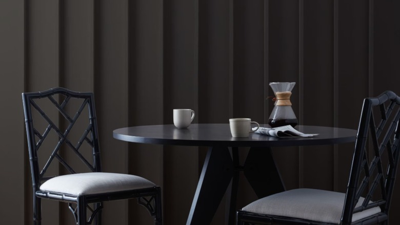 A dining area painted a deep black color.