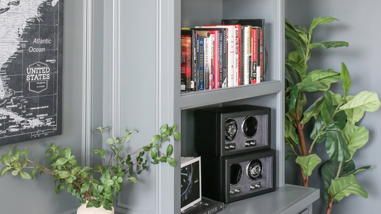 A nook painted Rocky Coast Gray with DVDs and accents.