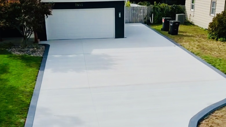 Driveway with colored, stamped concrete border.