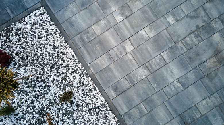 Decorative rock is used as a border for this driveway.