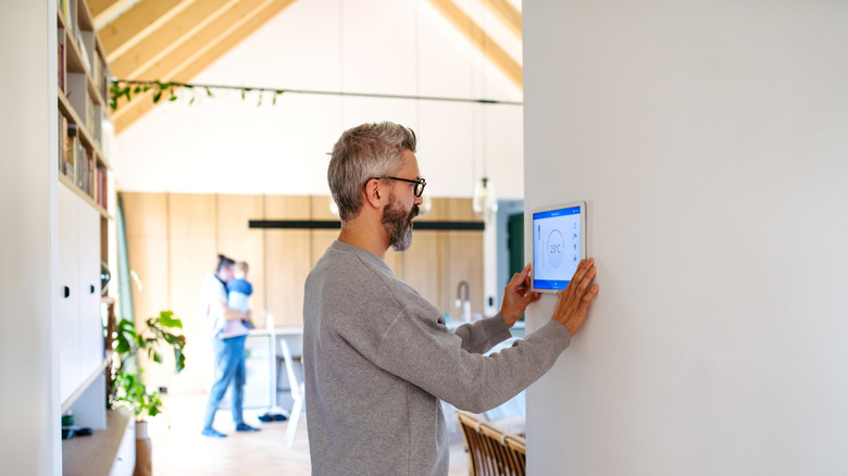Man using smart home control panel