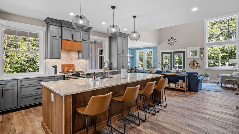 modern kitchen with granite bar with chic seating and open layout into living area