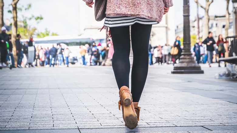 Woman wearing outfit with black leggings