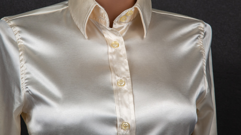 Woman wearing a cream-colored silk blouse