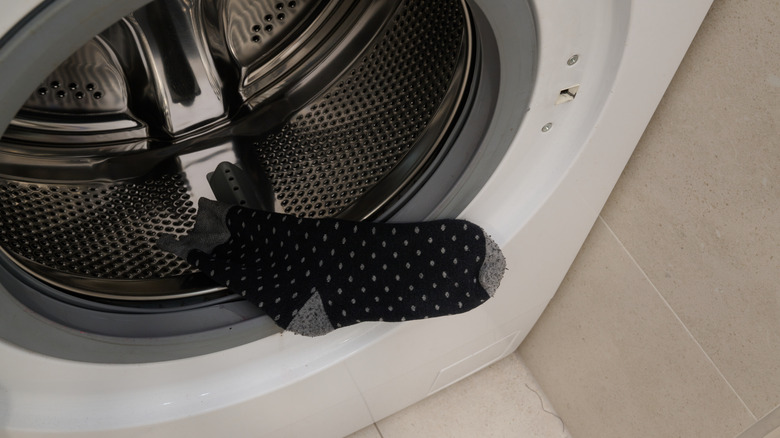 Black and grey sock in a washing machine