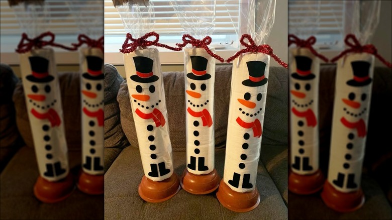 Toilet paper snowmen with a plunger base