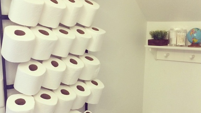 A thread rack holding rolls of toilet paper