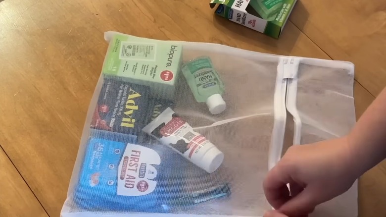 Placing first aid essentials inside a mesh laundry bag