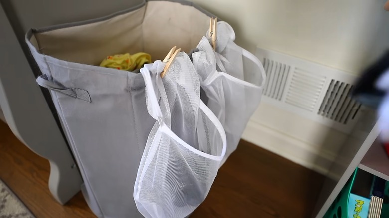 Small mesh laundry bags pinned to a hamper