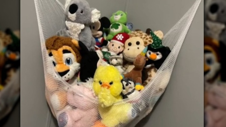 Stuffed toys in a white mesh hammock
