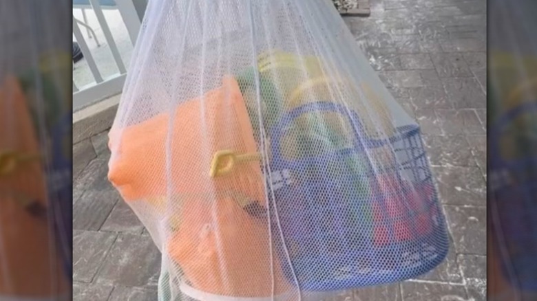Beach toys in a mesh laundry bag