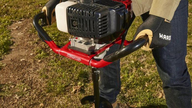 A person using Predator's Gas-Powered Earth Auger