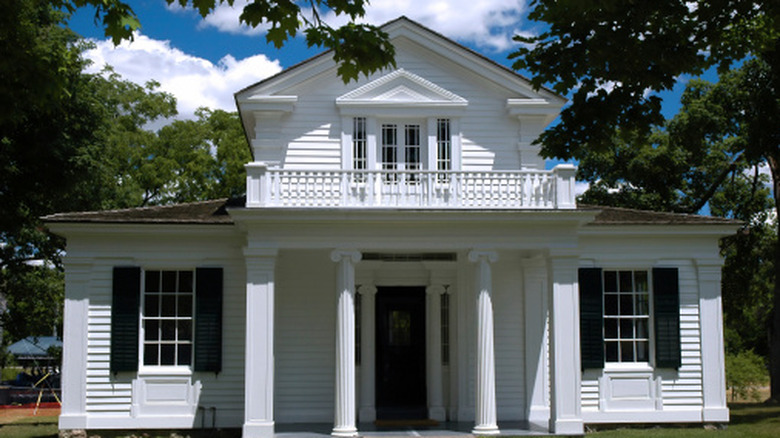 Greek revival home with columns and second floor verandah
